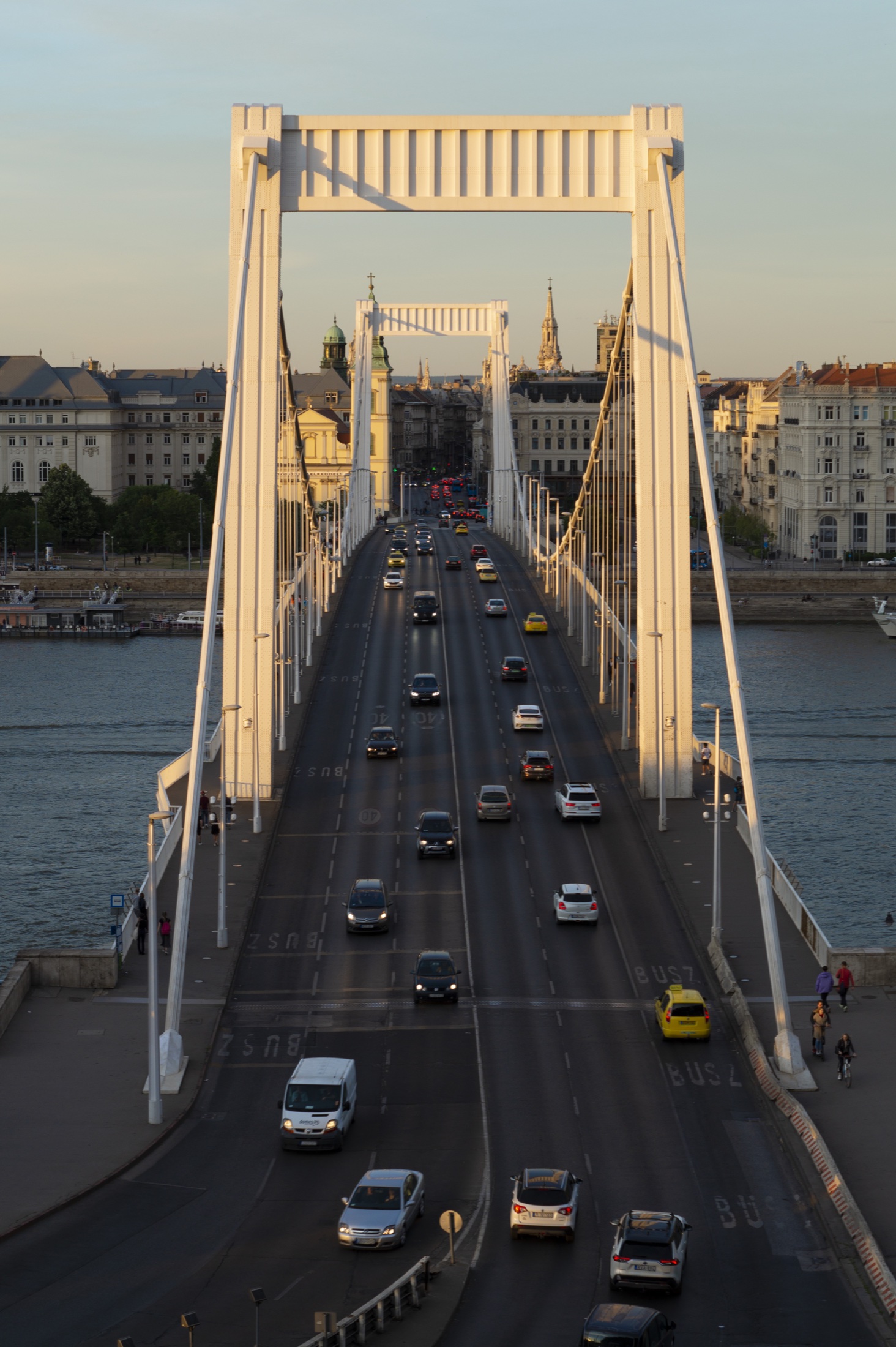 Looking down Elizabeth Bridge in Budapest at golden hour, traffic crossing the Danube
