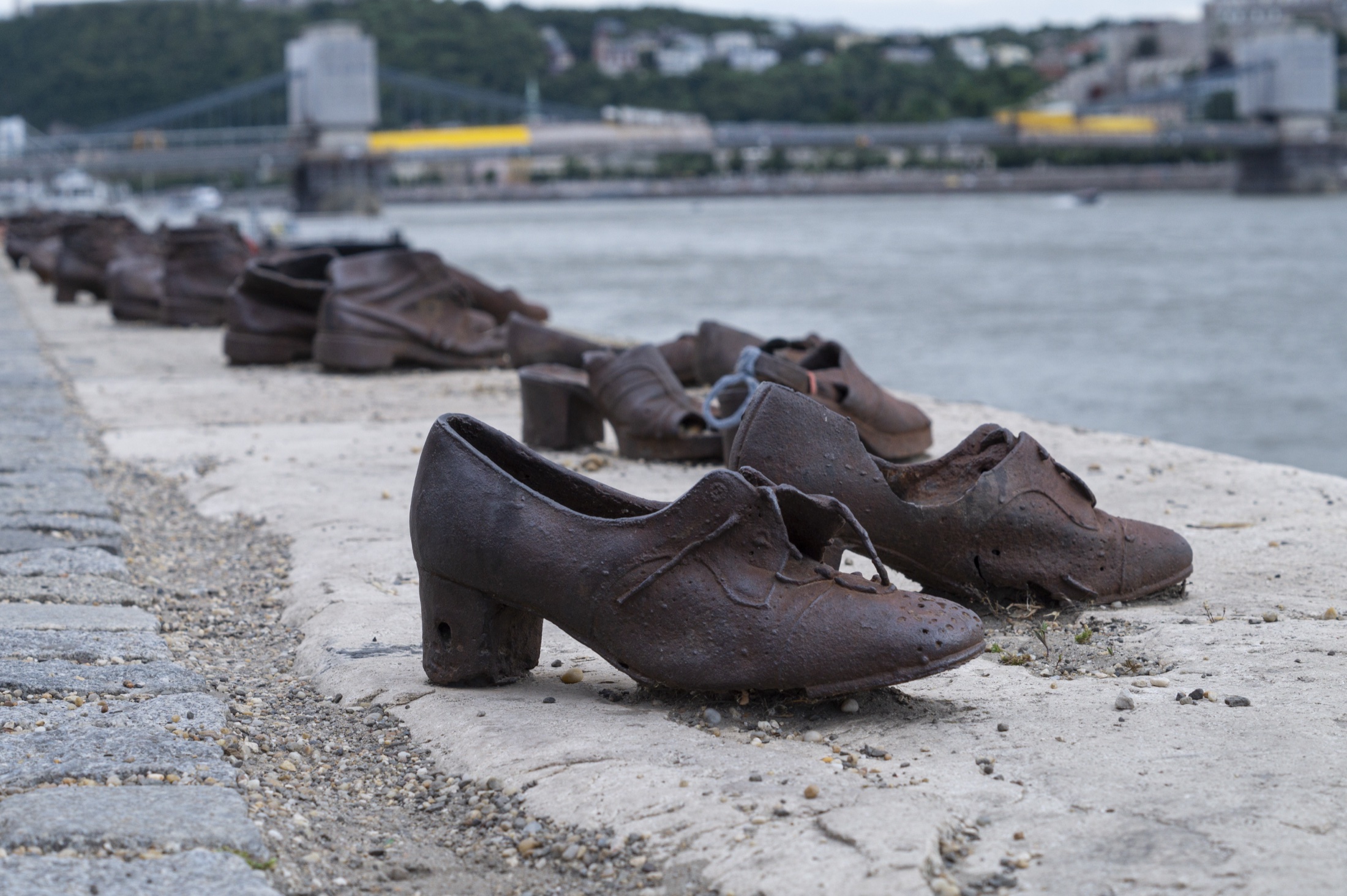 The Shoes on the Danube Bank memorial — bronze period shoes on the stone embankment of the Danube in Budapest