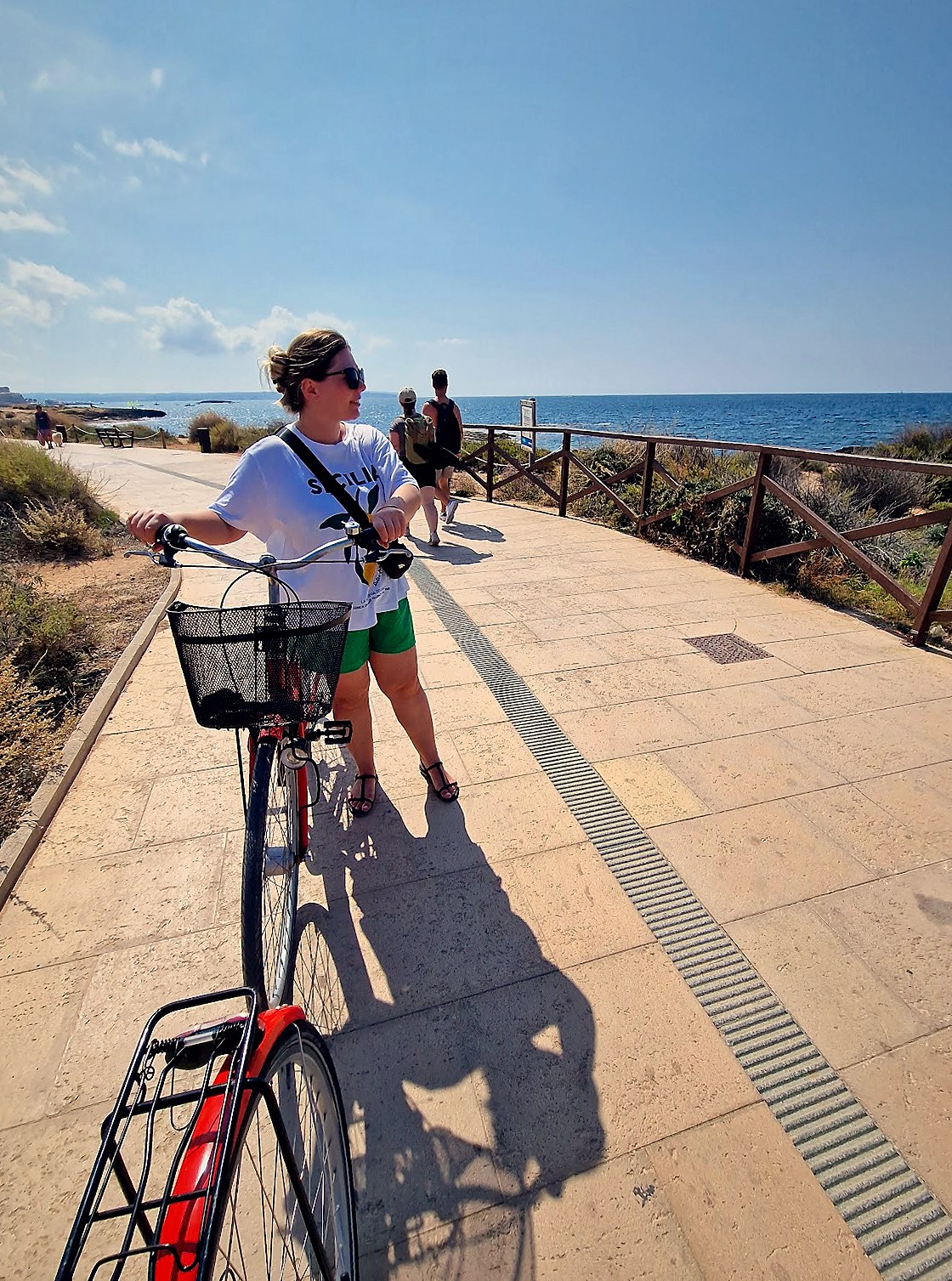 Pushing a bike along the seaside promenade in Ca'n Pastilla, Mallorca