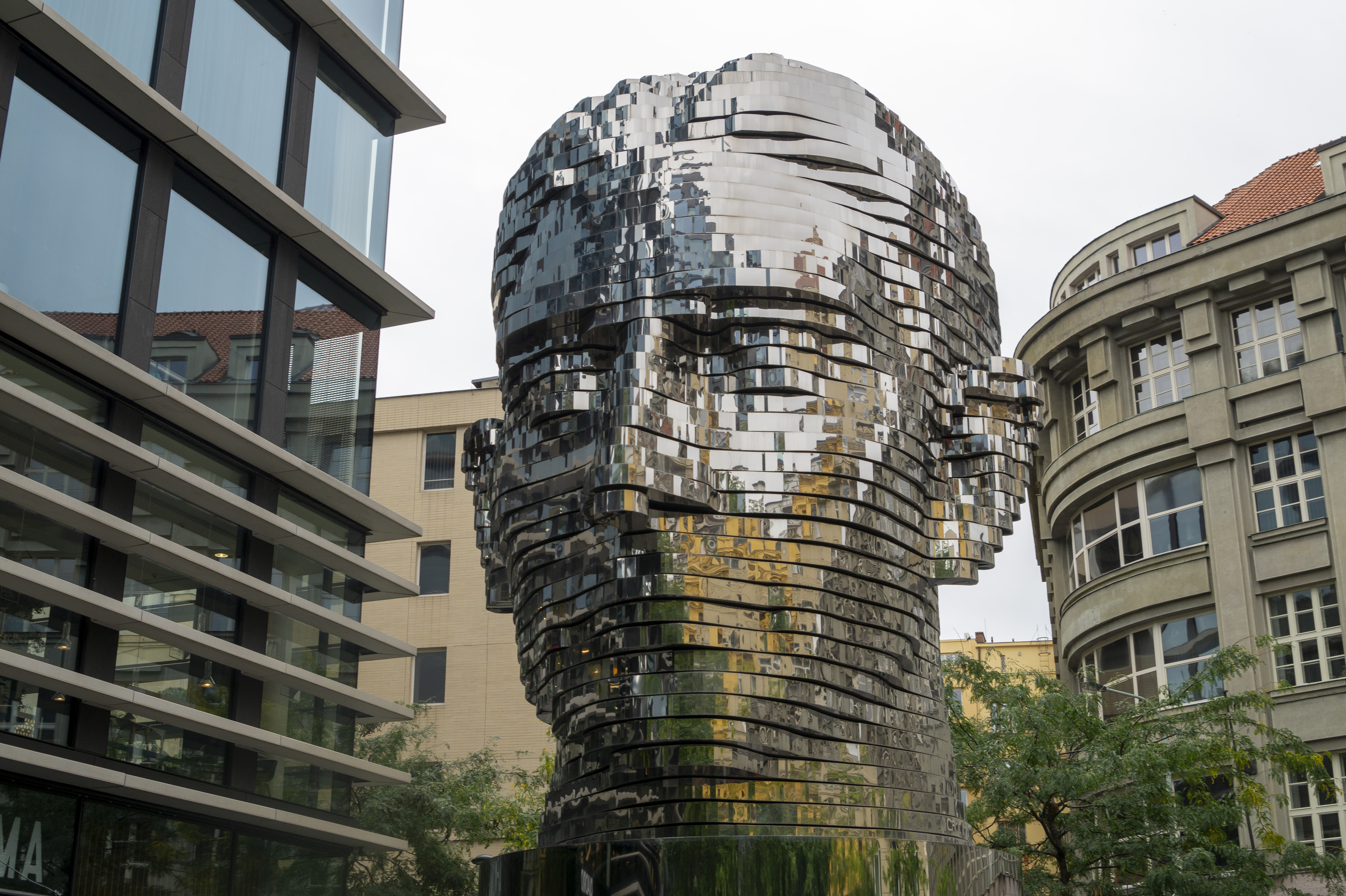 The Statue of Franz Kafka by David Černý — a giant 11 metre tall mirrored kinetic head made of 42 horizontal slices that rotate independently