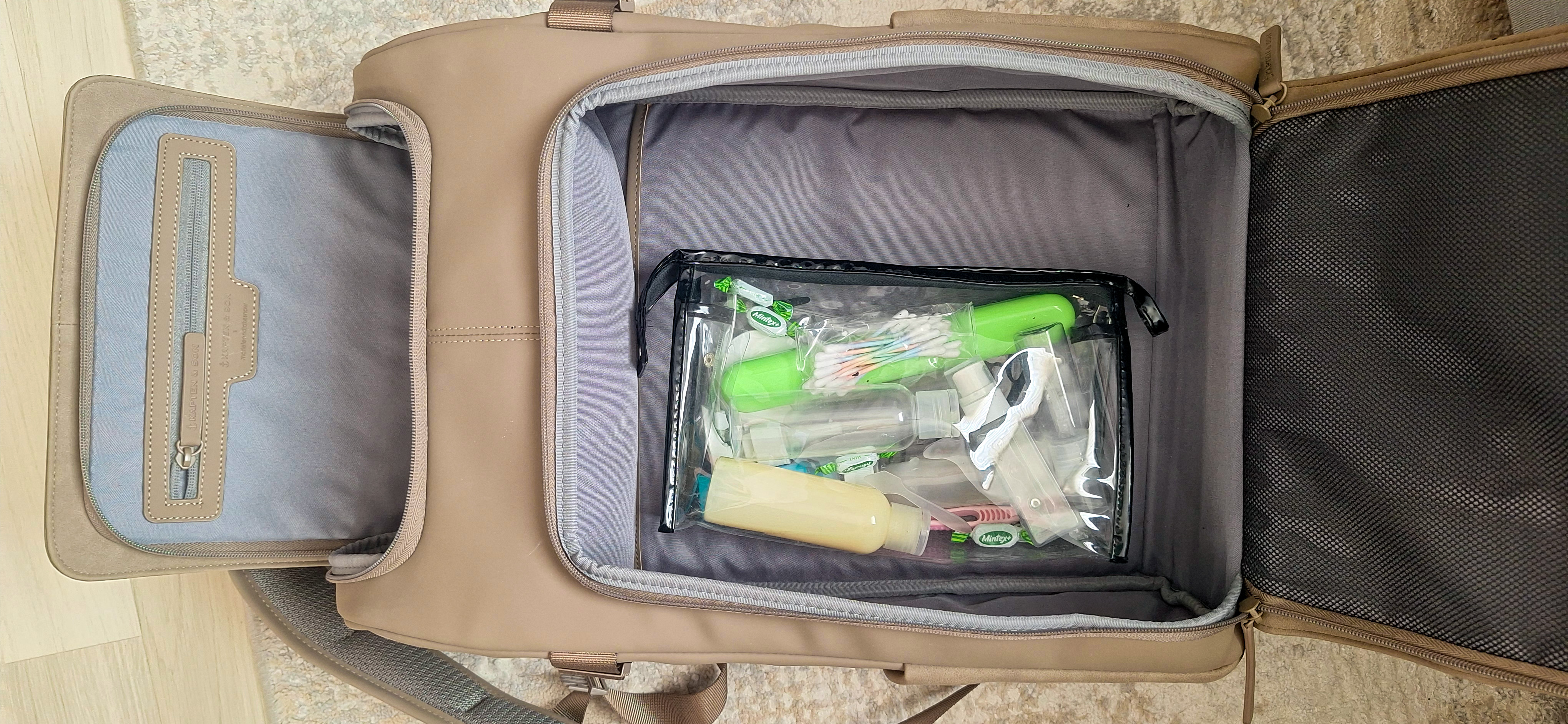 Open interior of the Kapten & Son Bali Medium showing a transparent toiletry pouch, organized compartments and an inner flap pocket