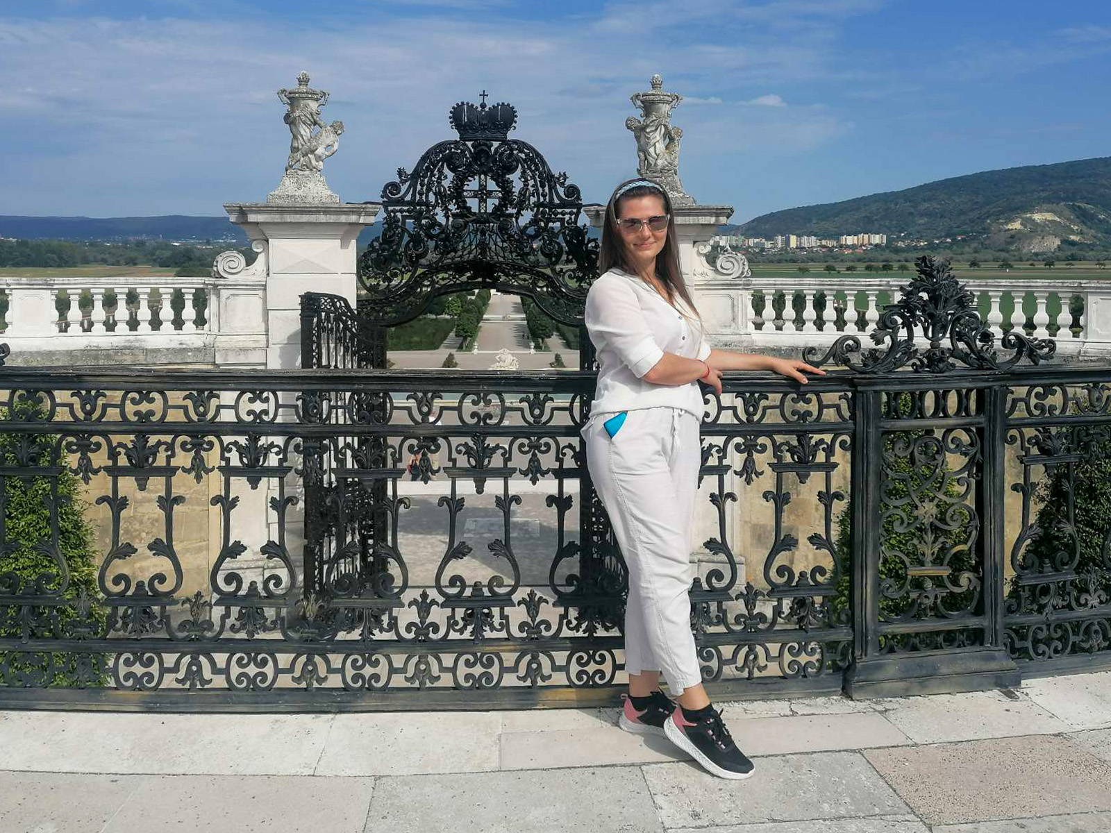 Standing by the wrought-iron fence with the Habsburg crown on the gate, overlooking the Danube plain from the terrace of Schloss Hof